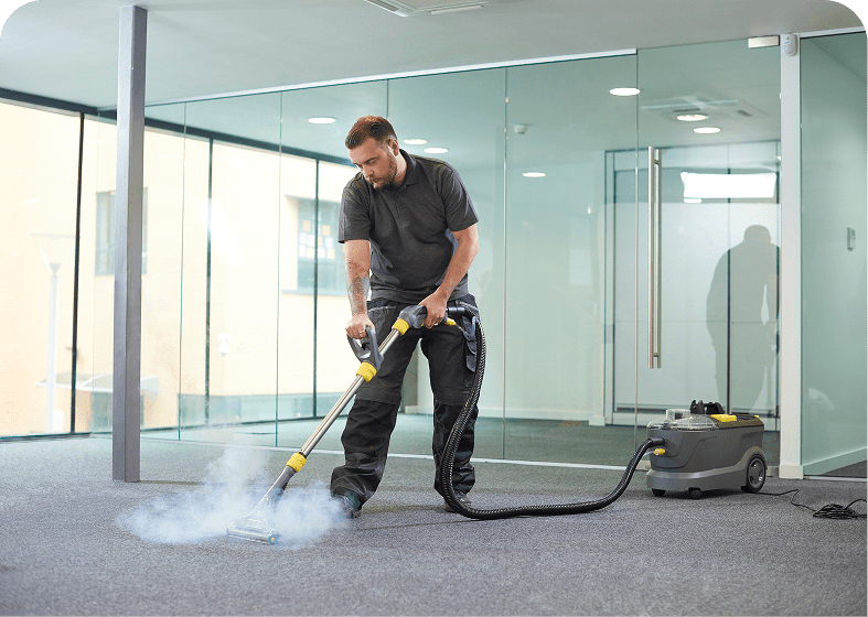 Man steam cleaning office carpet