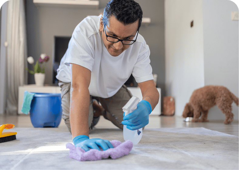 Person scrubbing floor with gloves on